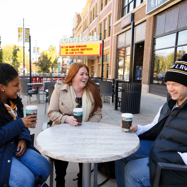 Students sitting with coffee cups